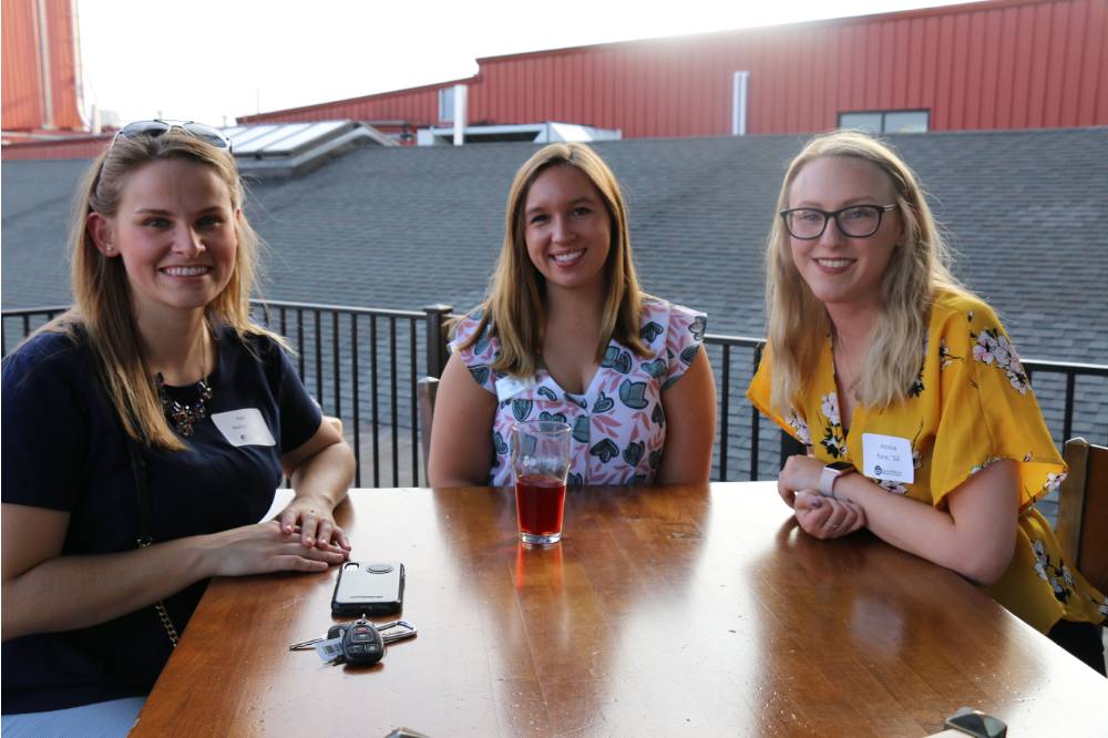 Three alumnae pose for a picture at Founders Brewing Co.